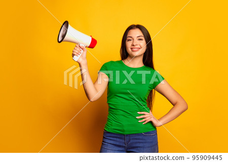 Portrait of young charming girl, student with megaphone isolated on color background. Concept of beauty, art, fashion, human emotions and facial expressions Portrait of young charming girl, student with megaphone isolated on color background. Concept of beauty, art, fashion, human emotions and facial expressions 95909445
