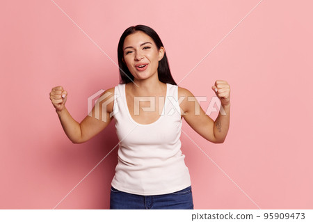 I won. Winning success happy woman celebrating being a winner. Dynamic image of caucasian female model on pink studio background. Victory, delight concept. Human facial emotions concept. I won. Winning success happy woman celebrating being a winner. Dynamic image of caucasian female model on pink studio background. Victory, delight concept. Human facial emotions concept. 95909473