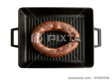 Homemade kangal sucuk made from spice mixtures used in Turkish cuisine in a heavy black cast iron grill pan 95909596
