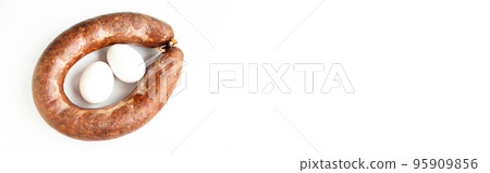 Homemade coiled sausage made of various spice mixes used in Turkish cuisine and two eggs, isolated on white background 95909856
