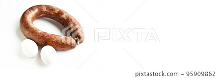 Homemade coiled sausage made of various spice mixes used in Turkish cuisine and two eggs, isolated on white background 95909862