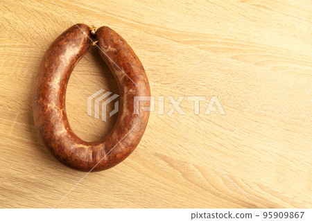 Kangal sucuk made from various spice mixtures used in Turkish cuisine, on oak cutting board 95909867