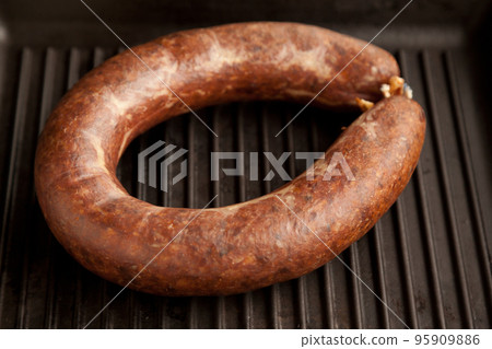 Kangal sucuk made from various spice mixturesHomemade kangal sucuk made from spice mixtures used in Turkish cuisine in a heavy black cast iron grill pan used in Turkish cuisine, isolated on white Kangal sucuk made from various spice mixturesHomemade kangal sucuk made from spice mixtures used in Turkish cuisine in a heavy black cast iron grill pan used in Turkish cuisine, isolated on white 95909886