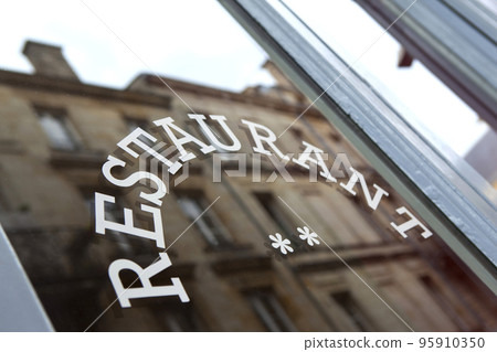 Window of a typical French restaurant in the city 95910350