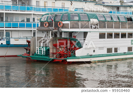 Stern of a vintage river paddle-boat standing at the pier 95910460