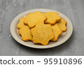 butter cookies isolated on light brown plate 95910896
