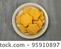 butter cookies isolated on light brown plate 95910897