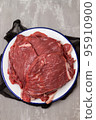 Fresh raw beef steak on white dish 95910900