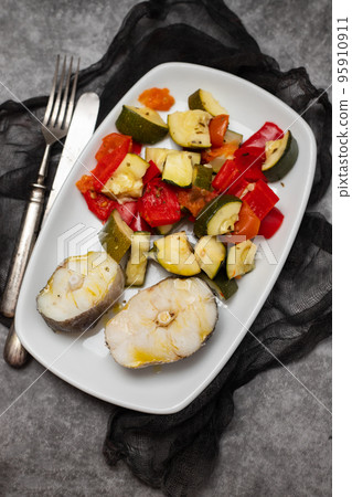 baked vegetables with boiled fish on white plate baked vegetables with boiled fish on white plate 95910911