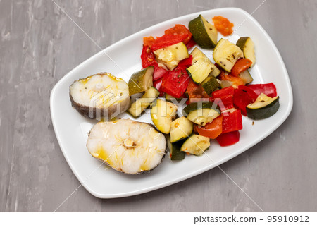baked vegetables with boiled fish on white plate baked vegetables with boiled fish on white plate 95910912