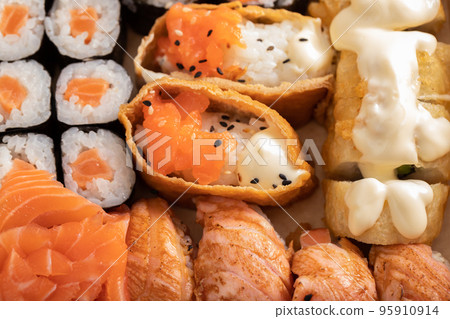 Assorted sushi nigiri and maki set. A variety of Japanese sushi with tuna, crab, salmon and rolls. Assorted sushi nigiri and maki set. A variety of Japanese sushi with tuna, crab, salmon and rolls. 95910914