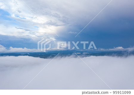 aerial view beautiful yellow sunrise above the mountain in phang Nga valley. slow floating fog blowing cover on the mountain look like as a sea of mist. scenery golden sunrise at horizon background. aerial view beautiful yellow sunrise above the mountain in phang Nga valley. slow floating fog blowing cover on the mountain look like as a sea of mist. scenery golden sunrise at horizon background. 95911099