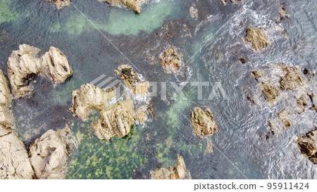 Aerial photo. A lot of boulders in the sea water, top view. Coastal cliffs of the North Atlantic. Seaside beautiful nature. Dramatic seascape of the north of Europe. Aerial photo. A lot of boulders in the sea water, top view. Coastal cliffs of the North Atlantic. Seaside beautiful nature. Dramatic seascape of the north of Europe. 95911424