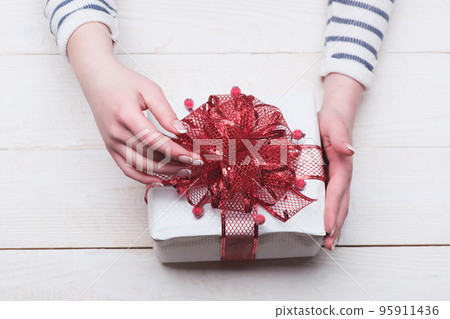 Present box for Christmas Eve with berries decoration. Present box for Christmas Eve with berries decoration. 95911436