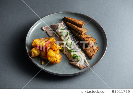 fresh marinated herring fish with potato and brown bread and onion isolated fresh marinated herring fish with potato and brown bread and onion isolated 95911759
