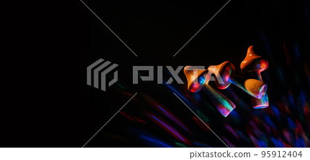 Psilocybin therapy as treatment of mental health challenges. psilocybin psychotropic magic psilocybin mushrooms on dark neon background 95912404