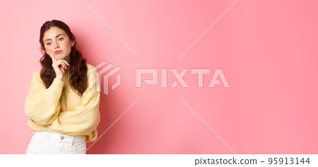 Thoughtful sad girl looking aside, spacing out, thinking what to do, standing moody and upset against pink background Thoughtful sad girl looking aside, spacing out, thinking what to do, standing moody and upset against pink background 95913144
