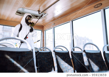 Cleaning and Disinfection transport. Man in protective suit washing , disinfection public transport Cleaning and Disinfection transport. Man in protective suit washing , disinfection public transport 95913659