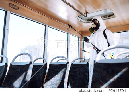 Cleaning and Disinfection transport. Man in protective suit washing , disinfection public transport 95913704
