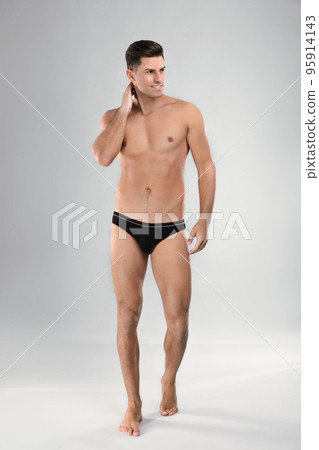 Handsome man in black underwear on light grey background 95914143