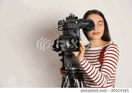 Operator with professional video camera on white background 95914165