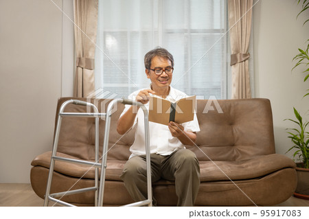 Sarcopenia older man is reading a book for relax at nursinghome . Sarcopenia is a degenerative disease of the muscle usually caused by the natural consequence of aging. 95917083