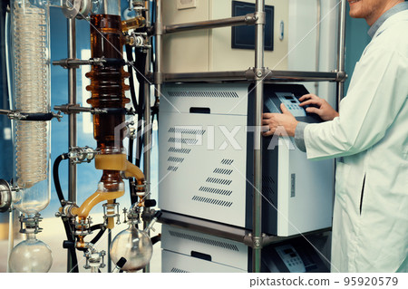 Scientist or apothecary in lab extract CBD hemp oil for medical purpose. 95920579