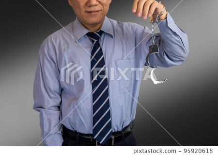 businessman removing handcuffs businessman removing handcuffs 95920618