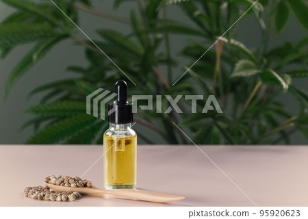 Legalized CBD oil extracted from marijuana in a glass bottle with a dropper lid. 95920623