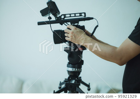 Photographer taking video of senior woman 95921329