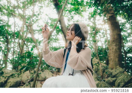Photo of a woman standing in nature Photo of a woman standing in nature 95921816
