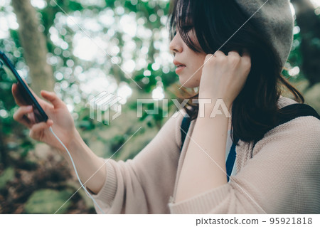 Photo of a woman standing in nature 95921818
