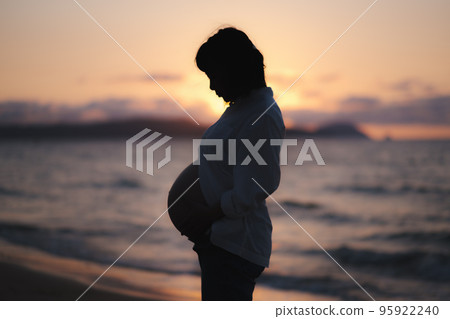 sunset and pregnant woman sunset and pregnant woman 95922240