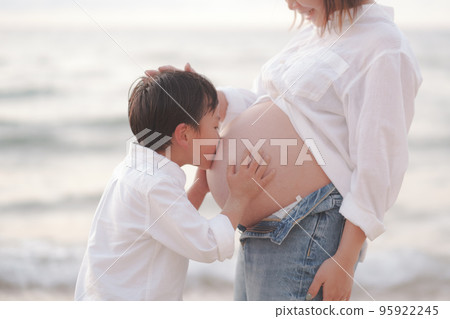 boy kissing mom's belly boy kissing mom's belly 95922245