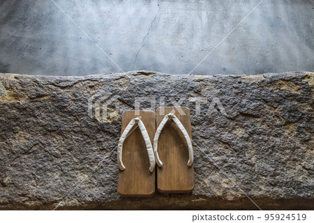 A bundle of clogs placed on a stone platform 95924519