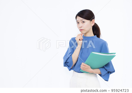A business woman in her thirties who is seriously worried A business woman in her thirties who is seriously worried 95924723