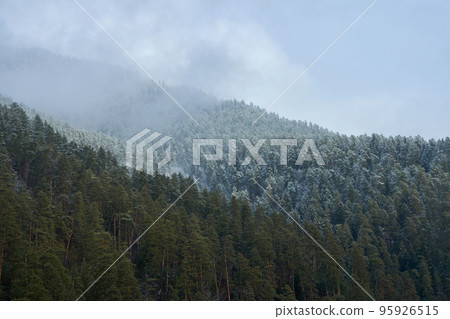 Winter mountain landscape. Small town between mountains. A cloud hangs over the city 95926515