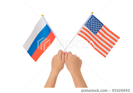 Female hand holding Russian and American flags, isolated on white background 95926950