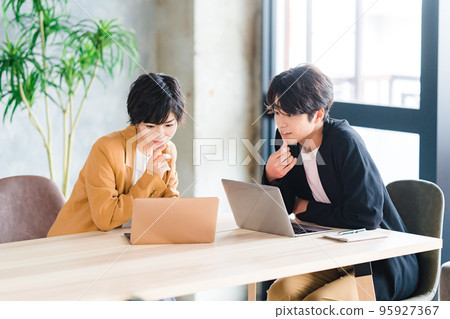 A woman instructing a junior man A woman instructing a junior man 95927367