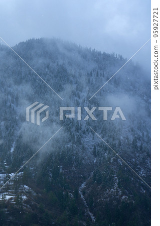 Winter mountain landscape. Small town between mountains. A cloud hangs over the city 95927721