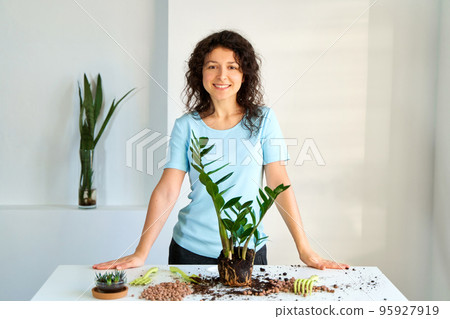 The girl will transplant a home flower because it has grown too large to fit in a pot 95927919