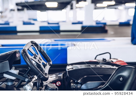 Steering wheel of a race kart on racing track 95928434