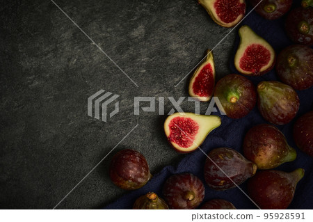 several fig fruits on a black background several fig fruits on a black background 95928591