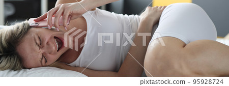 Upset blond woman screaming holding belly, calling to ambulance Upset blond woman screaming holding belly, calling to ambulance 95928724