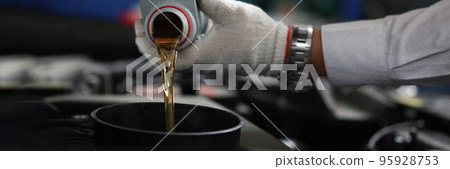 Auto mechanic refueling and pouring oil into engine motor ia car Auto mechanic refueling and pouring oil into engine motor ia car 95928753