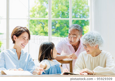 Family watching over elementary school students studying at home 95929309