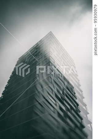 Glass building with cloudy sky angle shot Glass building with cloudy sky angle shot 95930979