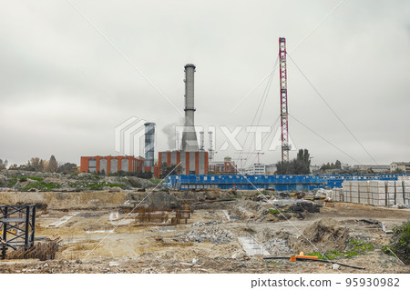 High pipes with power plant and construction site High pipes with power plant and construction site 95930982