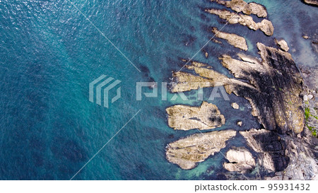 Rocks among the turquoise sea. Seascape, top view. Waters of the Atlantic Ocean. Space for text. Drone point of view. Rocks among the turquoise sea. Seascape, top view. Waters of the Atlantic Ocean. Space for text. Drone point of view. 95931432