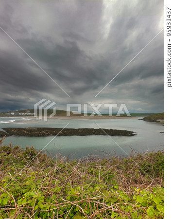 View of Clonakilty Bay on a cloudy day. Gloomy sky over the seashore. Beautiful seascape. The coastline of the south of Ireland, County Cork. View of Clonakilty Bay on a cloudy day. Gloomy sky over the seashore. Beautiful seascape. The coastline of the south of Ireland, County Cork. 95931437
